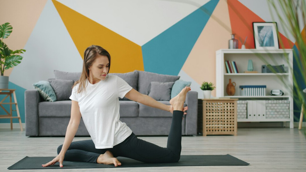 woman practicing yoga indoors
